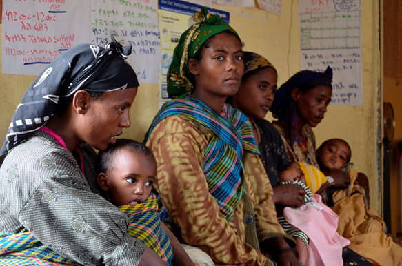 A health extension worker on her way to visit a household.